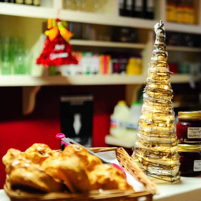The counter with croissants in a basket and jars of homemade raspberry jam