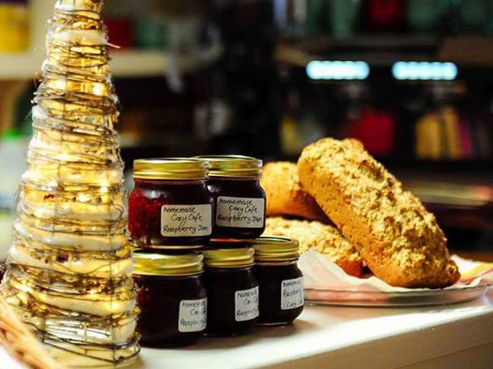 Jars of homemade raspberry jam and soda bread on the counter